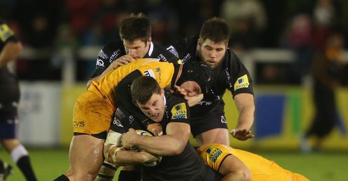 Mark Wilson of Newcastle is tackled by Carlo Festuccia L and Sam Jones Mark Wilson of Newcastle is tackled by Carlo Festuccia L and Sam Jones