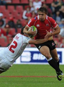 Stefan Watermeyer of Lions is tackled by Mike Harris of Reds Stefan Watermeyer of Lions is tackled by Mike Harris of Reds