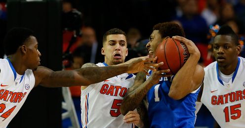 Kentucky's James Young contends with Florida's Casey Prather, Scottie Wilbekin and Will Yeguete