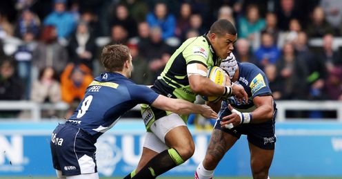 Luther Burrell of Northampton Saints is tackled by Dwayne Peel L and Sam Tuitupou of Sale Luther Burrell of Northampton Saints is tackled by Dwayne Peel L and Sam Tuitupou of Sale