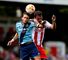 Diego Poyet of West Ham and Stevenage's Simon Walton vie for the ball