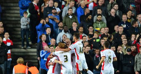 MK Dons celebrate knocking Man United out of the League Cup