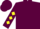 Maroon, yellow and black 'smiling face emblem', yellow diamonds on sleeves