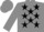 Grey body, black stars, grey arms, grey cap