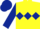 Yellow body, dark blue triple diamond, dark blue arms, dark blue cap