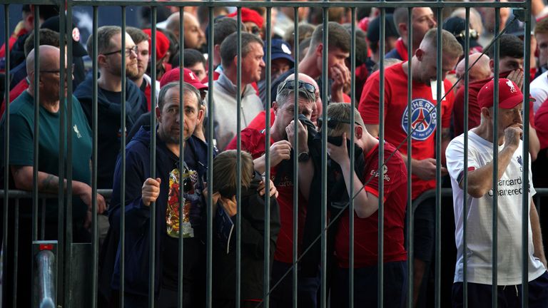 Supporters cover their faces as they try to get into the Stade de France. There were reports of police using pepper spray