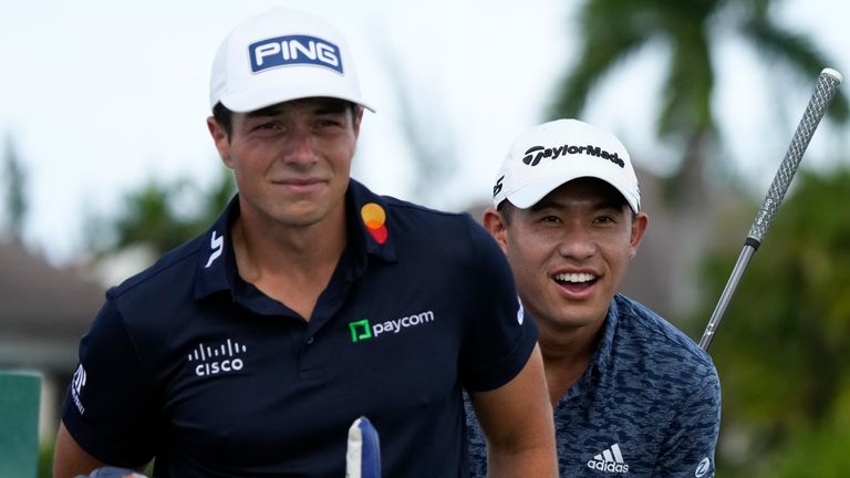 Viktor Hovland, of Norway, left, and Collin Morikawa, of the United States, look for the flag on the green before the tee off at the first hole during the first round of the Hero World Challenge PGA Tour at the Albany Golf Club, in New Providence, Bahamas, Thursday, Dec. 1, 2022. (AP Photo/Fernando Llano)