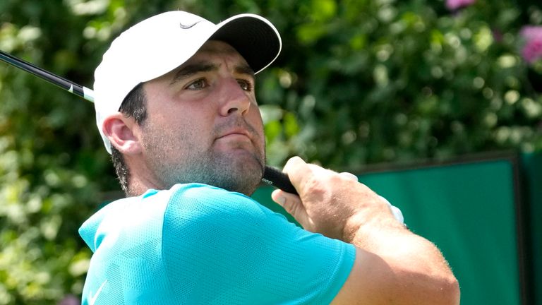 Scottie Scheffler watches his tee shot on the first hole during the final round of the BMW Championship golf tournament, Sunday, Aug. 20, 2023, in Olympia Fields, Ill. (AP Photo/Charles Rex Arbogast)