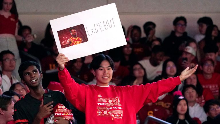 A fan holds up a sign for Southern California guard Bronny James prior to an NCAA college basketball game against Long Beach State Sunday, Dec. 10, 2023, in Los Angeles. (AP Photo/Mark J. Terrill)