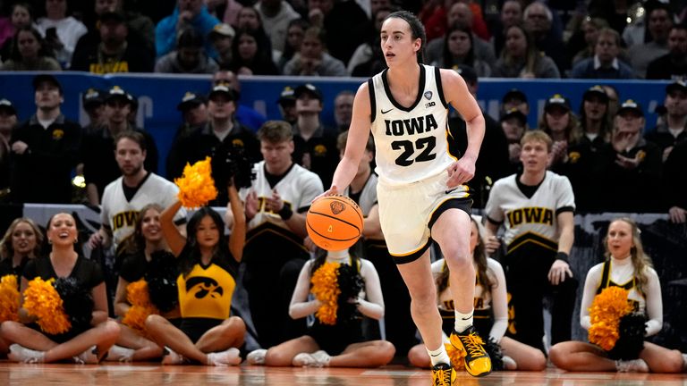 Iowa guard Caitlin Clark (22) drives up court during the first half of a Final Four college basketball game against UConn in the women&#39;s NCAA Tournament, Friday, April 5, 2024, in Cleveland. (AP Photo/Carolyn Kaster)