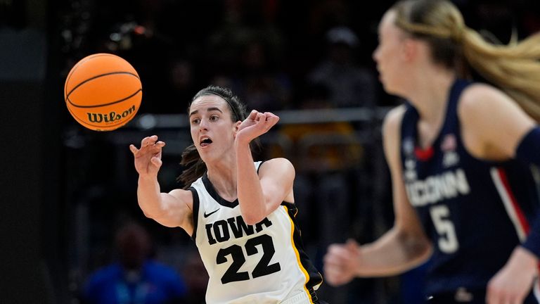 Iowa guard Caitlin Clark (22) passes up court in front of UConn guard Paige Bueckers (5) during the first half of a Final Four college basketball game in the women&#39;s NCAA Tournament, Friday, April 5, 2024, in Cleveland. (AP Photo/Carolyn Kaster)