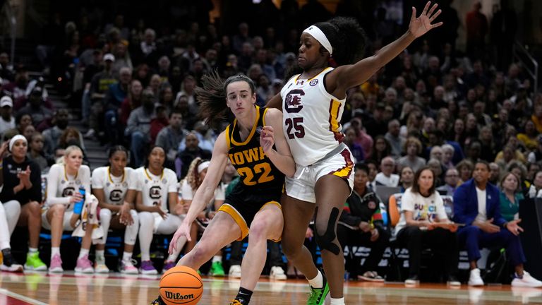 Iowa guard Caitlin Clark (22) drives past South Carolina guard Raven Johnson (25) during the first half of the Final Four college basketball championship game in the women&#39;s NCAA Tournament, Sunday, April 7, 2024, in Cleveland. (AP Photo/Carolyn Kaster)