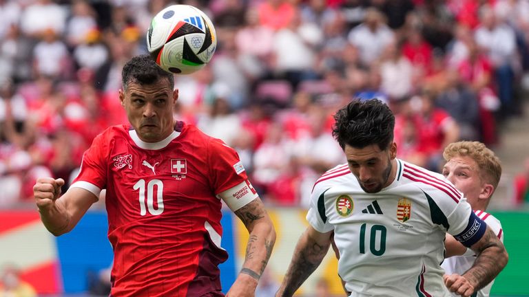 Switzerland&#39;s Granit Xhaka, left, and Hungary&#39;s Dominik Szoboszlai challenge for the ball during a Group A match between Hungary and Switzerland at the Euro 2024 soccer tournament in Cologne, Germany, Saturday, June 15, 2024. (AP Photo/Darko Vojinovic)