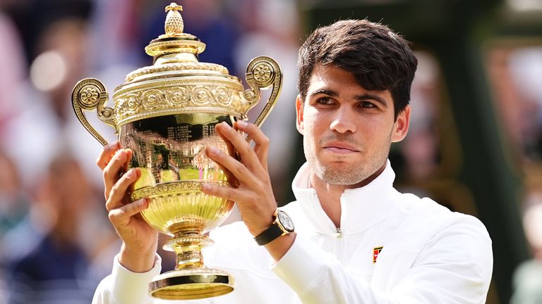 Carlos Alcaraz celebrates with the trophy after victory in the Gentlemen&#39;s Singles Final against against Novak Djokovic (not pictured) on day fourteen of the 2024 Wimbledon Championships at the All England Lawn Tennis and Croquet Club, London. Picture date: Sunday July 14, 2024.