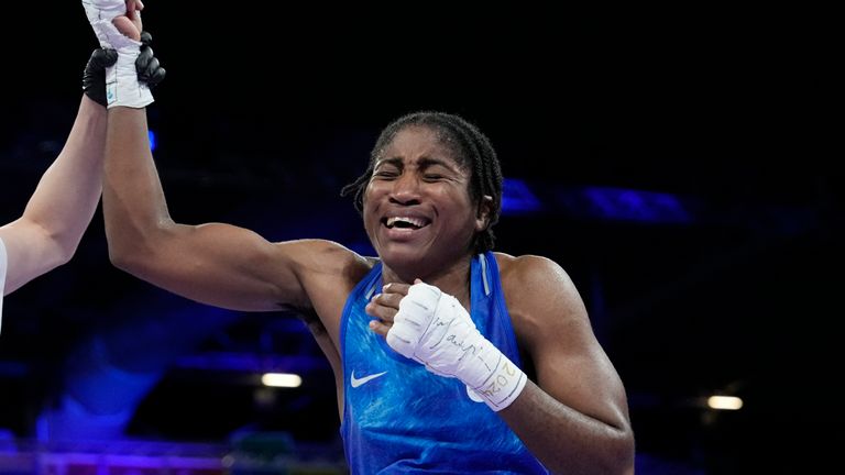 Refugee Olympic Team&#39;s Cindy Djankeu celebrates after defeating Canada&#39;s Tammara Thibeault in their women&#39;s 75 kg preliminary boxing match at the 2024 Summer Olympics, Wednesday, July 31, 2024, in Paris, France. (AP Photo/Ariana Cubillos)