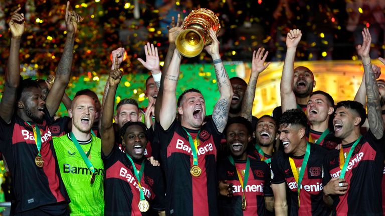 Leverkusen&#39;s Granit Xhaka lifts the trophy after the German Soccer Cup final match between 1. FC Kaiserslautern and Bayer Leverkusen at the Olympic Stadium in Berlin, Germany, Saturday, May 25, 2024. (AP Photo/Matthias Schrader)