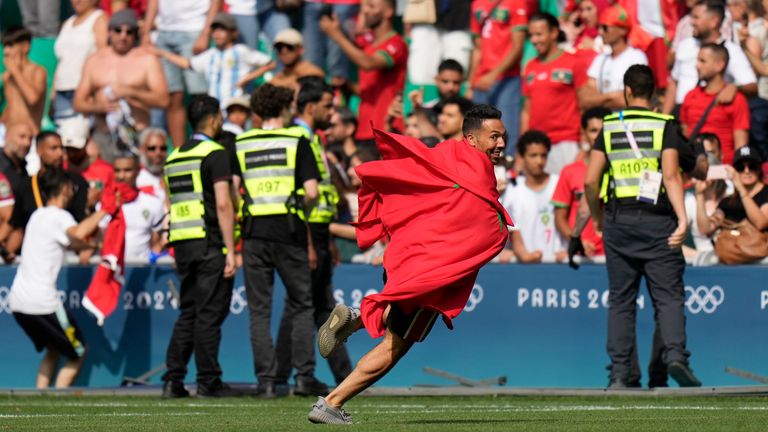 Invaders run on the pitch during the men&#39;s Group B soccer match between Argentina and Morocco at Geoffroy-Guichard Stadium at the 2024 Summer Olympics, Wednesday, July 24, 2024, in Saint-Etienne, France. (AP Photo/Silvia Izquierdo)