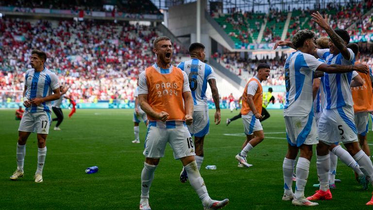 Argentina&#39;s players celebrate their side&#39;s second goal scored by Cristian Medina during the men&#39;s Group B soccer match between Argentina and Morocco at Geoffroy-Guichard Stadium at the 2024 Summer Olympics, Wednesday, July 24, 2024, in Saint-Etienne, France. (AP Photo/Silvia Izquierdo)