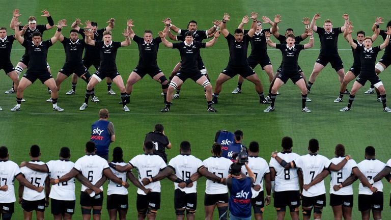 New Zealand&#39;s players perform the haka as players for Fiji look on in San Diego. (AP Photo/Gregory Bull)