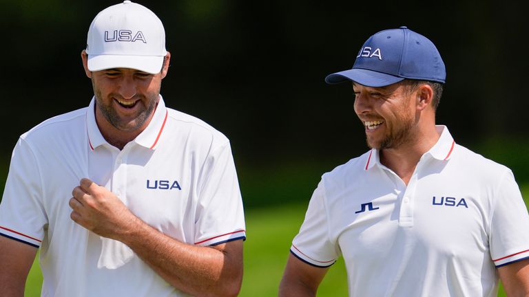 Scottie Scheffler, left, and Xander Schauffele, both of the United States, laugh on the 13th green during a practice round for the men&#39;s golf event at the 2024 Summer Olympics, Wednesday, July 31, 2024, at Le Golf National in Saint-Quentin-en-Yvelines, France. (AP Photo/George Walker IV)