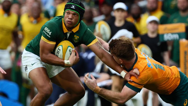 South Africa&#39;s Kurt-Lee Arendse.left, fends off a tackle from Australia&#39;s Andrew Kellaway during their rugby union test match in Brisbane, Saturday, Aug. 10, 2024. (AP Photo/Tertius Pickard)