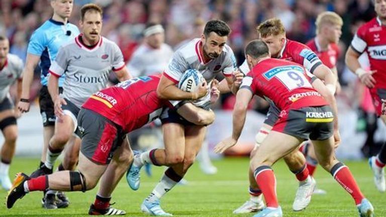 Saracens' Alex Lozowski is tackled by Gloucester's Seb Blake and Gloucester's Tomos Williams during the Gallagher Premiership match at Kingsholm Stadium, Gloucester. Picture date: Saturday September 21, 2024.