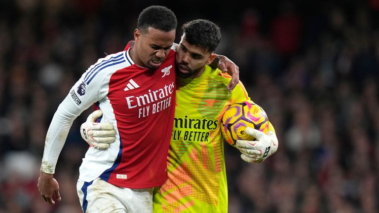 Gabriel goes off injured with help of Arsenal's goalkeeper David Raya (AP Photo/Alastair Grant)