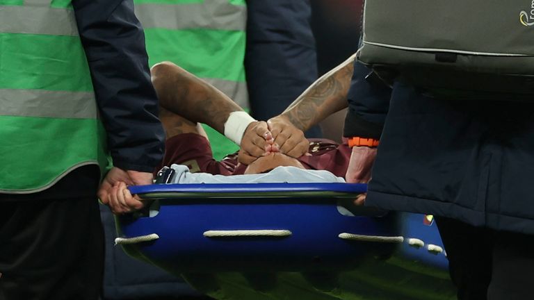 Medical staff carry Manchester City's Savinho from the pitch after sustaining an injury (AP Photo/Ian Walton)