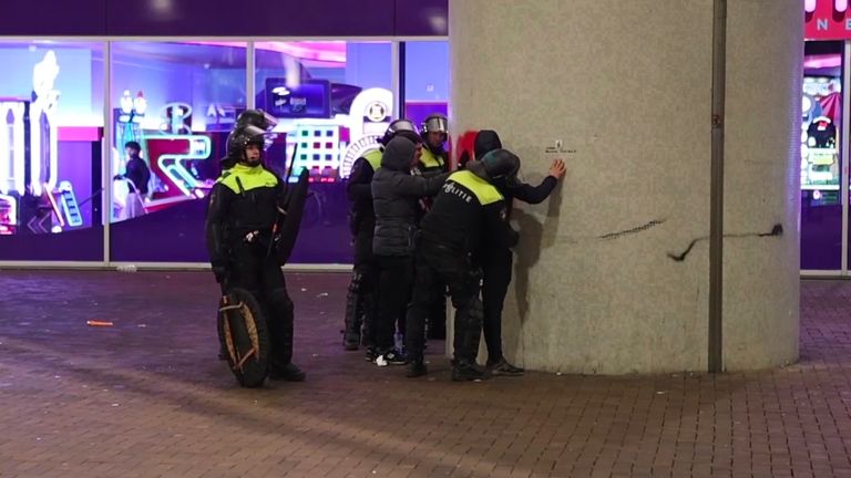 Police frisk pro-Palestinian supporters near the Ajax ground