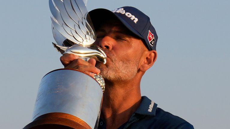 Paul Waring of England kisses the trophy during the awards ceremony after winning the Abu Dhabi Golf Championship in Abu Dhabi, United Arab Emirates, Sunday, Nov. 10, 2024. (AP Photo/Altaf Qadri) 