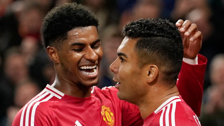 Manchester United's Casemiro, right, celebrates with his teammate Marcus Rashford after scoring his side's fourth goal during the English League Cup soccer match between Manchester United and Leicester City at the Old Trafford stadium in Manchester, England, Wednesday, Oct. 30, 2024. (AP Photo/Dave Thompson)