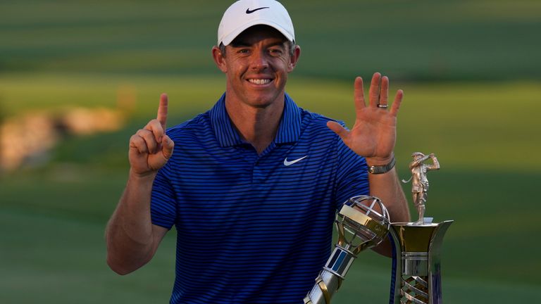 Rory McIlroy of Northern Ireland poses with the DP World Tour Championship trophy and the Race to Dubai trophy after winning the World Tour Golf Championship in Dubai, United Arab Emirates, Sunday, Nov. 17, 2024. (AP Photo/Altaf Qadri )