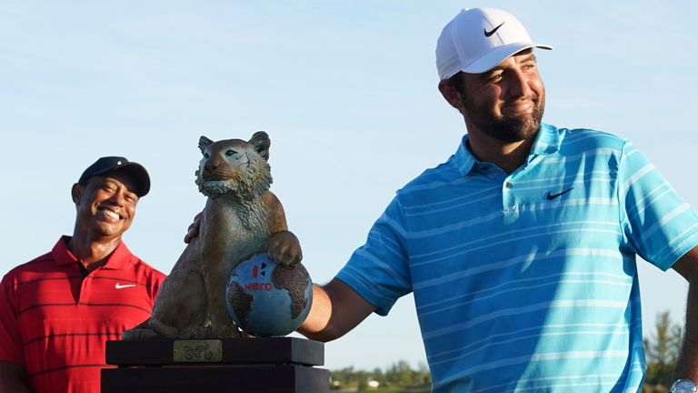 Scottie Scheffler, of the United States, right, poses with the trophy next to Tiger Woods, of United States, after winning the Hero World Challenge PGA Tour at the Albany Golf Club, in New Providence, Bahamas, Sunday, Dec. 3, 2023. (AP Photo/Fernando Llano)