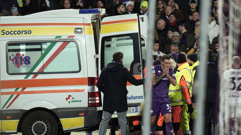 An ambulance enters the field as Fiorentina's Edoardo Bove, injured, is surrounded by players during the Serie A soccer match between Fiorentina and Inter at the Artemio Franchi Stadium in Florence, Italy, Sunday Dec. 1, 2024. The match was suspended and finally postponed as the injures appeared to be serious.  (Massimo Paolone/LaPresse via AP)