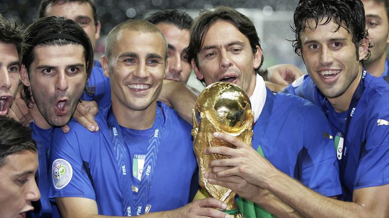 Vincenzo Iaquinta, Fabio Cannavaro, Filippo Inzaghi and Fabio Grosso celebrate with the World Cup trophy after the final of the soccer World Cup between Italy and France in the Olympic Stadium in Berlin, Sunday, July 9, 2006. Italy won 5-3 in penalty kicks after a 1-1 draw after extra time.