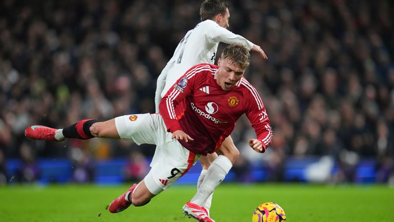 Manchester United's Rasmus Hojlund, front, falls on the pitch challenged by Fulham's Timothy Castagne during the English Premier League soccer match between Fulham and Manchester United at Craven Cottage stadium in London, Sunday, Jan. 26, 2025. (AP Photo/Kirsty Wigglesworth)