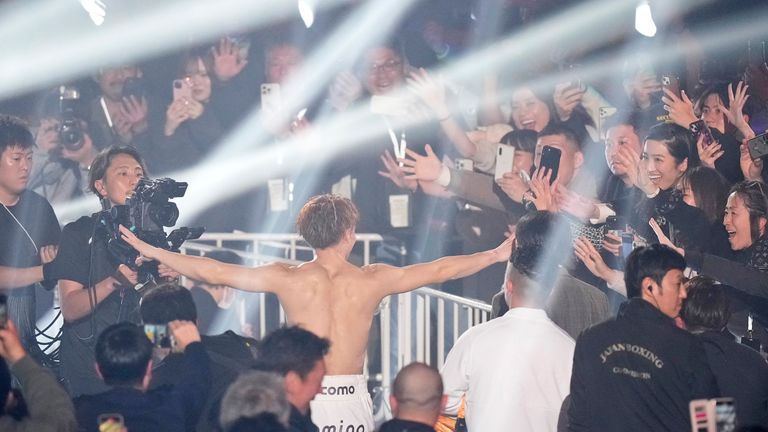 Fans cheer as undisputed champion Naoya Inoue leavse the ring after defending his unified WBC, WBA, IBF and WBO super-bantamweight world titles