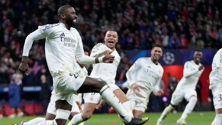 Real Madrid players celebrate after winning the penalty shootout during the Champions League round of 16, second leg, soccer match between Atletico Madrid and Real Madrid at the Metropolitano stadium in Madrid, Spain, Wednesday, March 12, 2025. (AP Photo/Bernat Armangue)