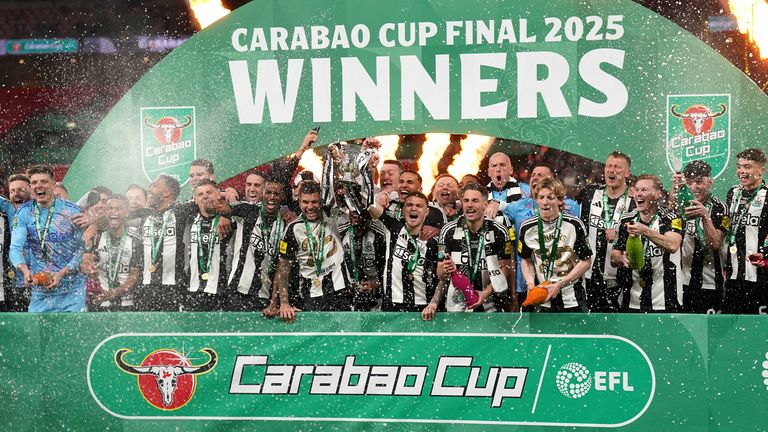 Newcastle United's Bruno Guimaraes and Kieran Trippier lift the Carabao Cup trophy with team-mates