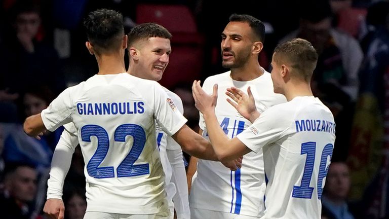 Christos Tzolis celebrates with his team-mates after scoring Greece's third goal at Hampden Park