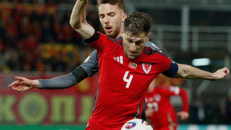Wales' Ben Davies, front, duels for the ball with North Macedonia's Nikola Serafimov during a World Cup 2026 group J qualifying soccer match between North Macedonia and Wales at National Arena Todor Proeski in Skopje, North Macedonia, Tuesday, March 25, 2025. (AP Photo/Boris Grdanoski)