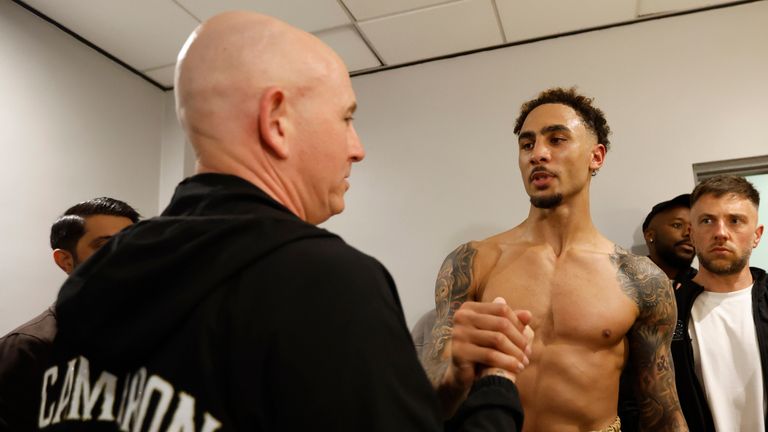 Whittaker shakes hands with Grant Smith in the changing room