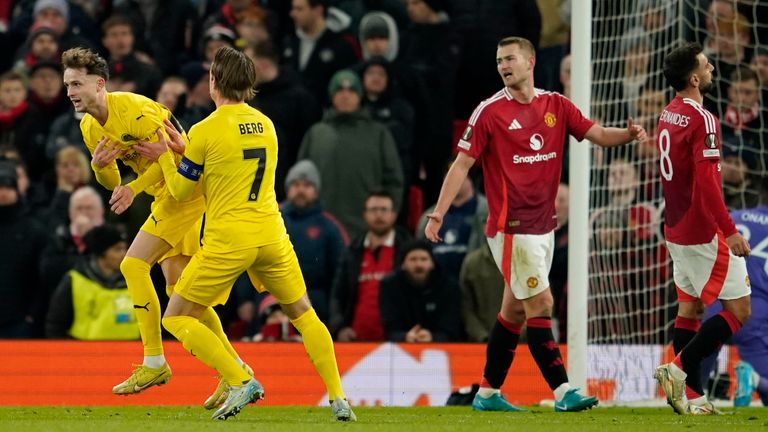 Glimt's Hakon Evjen, left, celebrates with Glimt's Patrick Berg after scoring his side's opening goal during the Europa League opening phase soccer match between Manchester United and Bodo Glimt, at the Old Trafford stadium in Manchester, England, Thursday, Nov. 28, 2024. (AP Photo/Dave Thompson)