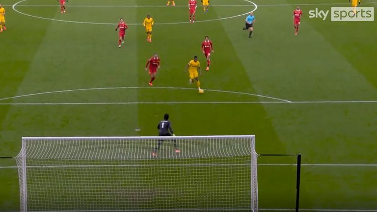 Wolves player Marshall Munetsi runs through on goal against Liverpool's Alisson Becker