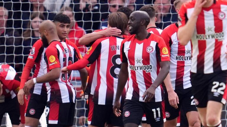 Christian Norgaard is mobbed by his team-mates after scoring Brentford's fourth goal against Brighton