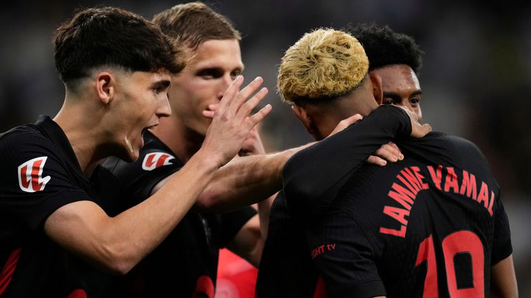 Barcelona players celebrate after a goal during a Spanish La Liga soccer match between Espanyol and Barcelona in Barcelona, Spain, Thursday, May 15, 2025. (AP Photo/Jose Breton)