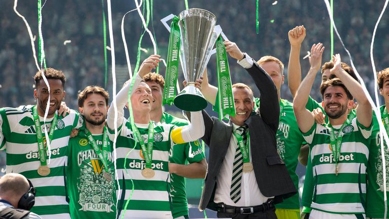 Celtic's Callum McGregor and manager Brendan Rodgers lift the Scottish Premiership trophy