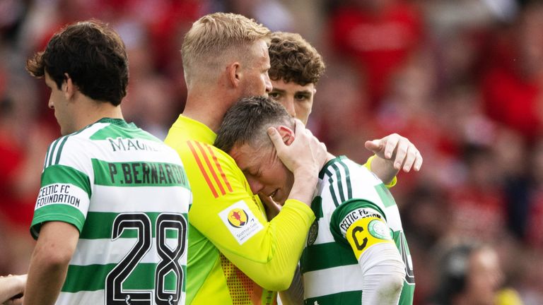 Celtic's Callum McGregor is consoled by Kasper Schmeichel 