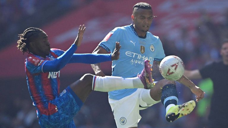 Manuel Akanji is challenged by Eberechi Eze 