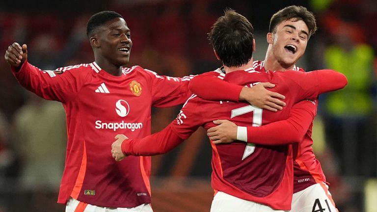Mason Mount (centre) celebrates scoring Manchester United's fourth goal with team-mates Kobbie Mainoo (left) and Harry Amass (right) 